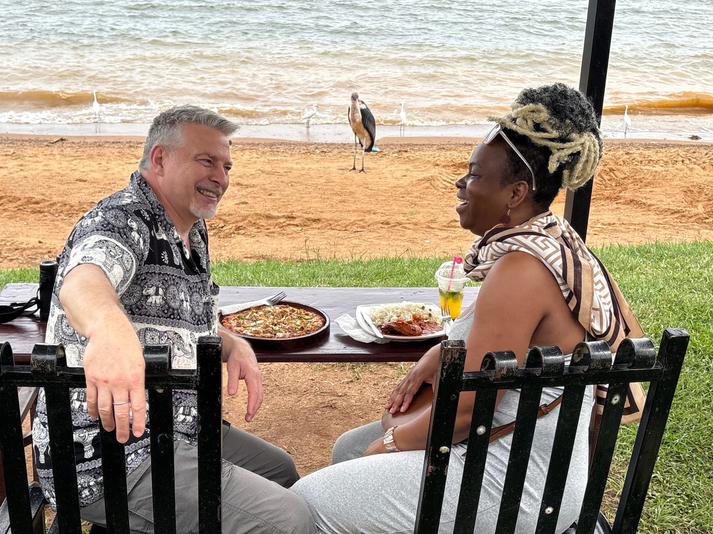 Guests enjoying lunch beside the sand of a private beach on Lake Victoria
